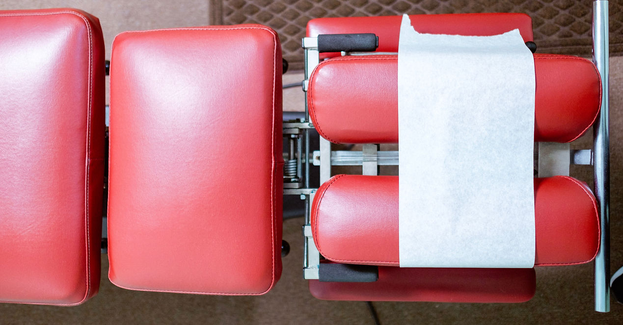 A red chair adorned with two white cushions, creating a vibrant and inviting seating area.